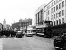 View: s23246 Trams including No. 497 outside the newly opened C and A Modes Ltd., Nos. 59 - 65 High Street showing the junction with Fitzalan Square around 1955-60