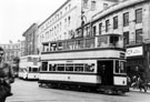 View: s23252 Trams on High Street outside Nos. 59 - 65 C and A Modes Ltd., department store,