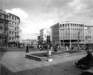 View: s23256 The junction of High Street and Market Place showing Peter Robinson Ltd. (right) The Yorkshire Insurance House (left) and Horne Brothers Ltd., outfitters with the Vulcan Sculpture by Boris Tietze, Angel Street