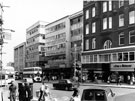 View: s23257 Nos. 20 Lilley and Skinner Ltd., boot dealers; 24 Hope Brothers Ltd., outfitters; 26/28 John Collier Ltd., tailors; 30/34, Saxone Shoe Co. Ltd.; Norwich Union Buildings; Norwich Union Insurance Society and Walshs of Sheffield,  High Street