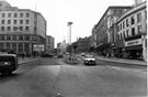 View: s23258 High Street from the junction with Fitzalan Square looking towards Castle Square with Marples Hotel, (No. 4 Fitzalan Square, left) and G.A. Dunn and Co., outfitters and Nos. 59 - 65 C and A Modes Ltd., department store (right)
