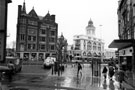 View: s23304 Rainy day, High Street, taken from the bottom of Fargate looking towards Spoils Kitchen Reject Shop underneath Parade Chambers (left) and Bradford and Bingley, Telegraph House (formerly Kemsley House) with Boots the Chemist extreme right