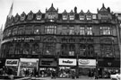 View: s23315 Carmel House; Nos. 53 Girlywig, wig specialists; 55 Cornell Furs, furriers; 57 Willerby and Co. Ltd., tailors; 59 Bradleys Music; musical instruments; 61 Dr. Scholl Ltd., leg and foot care and 63 Stag Ltd., menswear, Fargate