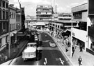 View: s23709 Elevated view of Haymarket looking towards Castle Market showing Nos. 13 - 15 Brunswick Hotel; 17, Etams Ltd.; 21 A. Davy and Sons Ltd. (left); Nos. 20/22 Montague Burton Ltd., tailors; F.W. Woolworth and Co. Ltd, department store (right)