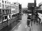 View: s23715 Elevated view of Haymarket looking towards Castle Market and Waingate showing Nos. 13/15, Brunswick Hotel; 17, Etam Ltd.; 21 A. Davy and Sons Ltd.(left); Nos. 20/22 Montague Burton Ltd., tailors;  F.W. Woolworth and Co. Ltd, department store