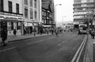 View: s23724 Shops including Ice Flow Ltd., frozen foods; Etam Ltd., ladies gowns, Haymarket looking towards Castle Market and Waingate