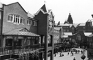 View: s24030 Elevated view of Orchard Square looking towards Fargate showing Sherratt and Hughes, book shop;  The Body Shop and one face of the Clock Tower with the striking bells