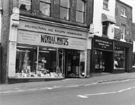 Nos. 8 - 10 Neville Watts of Sheffield, architectural and builders ironmongery;  6 David W. Shepherd, opthalmic optician and 4 Artisan, yarns, Fitzwilliam Street 