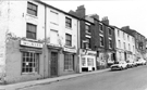 Nos. 64 Milners Musical Instruments, (prop. John Copestake); 62 Mrs. B's Sandwich Shop; 60 derelict Magick; derelict 58 G. Darkler, butcher; 56 and 54 Globe Inn, Howard Street 