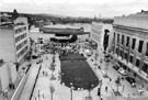 Elevated view from the Town Hall extension of Tudor Square with the Catalan Giants performing during the World Student Games Cultural Festival looking towards the Crucible Theatre with the Lyceum; Central Library right