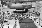 Elevated view from the Town Hall extension of Tudor Square with the Catalan Giants performing in front of the Crucible Theatre during the World Student Games Cultural Festival with the Lyceum Theatre right