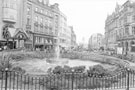View: s24470 Goodwin Fountain, Fargate looking towards High Street showing the entrance to Orchard Square and No. 58, Dixons Ltd., photographical equipment; audio visual and electronics store 
