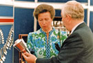 Princess Anne visiting Thessco Ltd, precious metal manufacturers, Royds Mills, Windsor Street, looking at a replica of the World Student Games torch