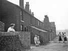 View: s24778 Mr. Vincent Lawrence Bryan with his children Stephen John; Kathleen and Pauline Mary in front of Nos. 7-12, Canal Cottages, Tinsley Park Road (demolished 1958) with the Sheff and SYK Navigation right