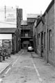 Clay Lane looking towards the entrance to rear of Butcher Works, Eyre Lane with M. D. Finney, furniture maker and Alan Edson, woodworkers, Unity House, Arundel Gate (left)