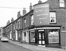 Nos. 26, E. Dixon, corner shop and off licence; 28, Gerald's, gents hairdresser and 24-44, Grimesthorpe Road from the junction of Clun Road looking towards with Ditchingham Road