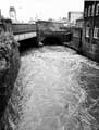 View: s25878 Sheaf Street over the River Sheaf in flood showing Sheaf Island Weir with Sheaf House in the background 