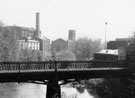 View: s26342 Iron Bridge (footbridge) over the River Don from Borough Bridge looking towards Manchester Hotel; John Aizelwood Ltd., Crown Corn Mill and Holy Trinity Church, Nursery Street in the background 