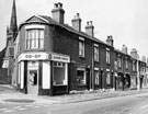 Nos. 99, South Yorkshire District Co-op Laundries Association Ltd. (SYD Laundry),; 101, G. Barron, gents hairdresser; 103; 105 etc, Petre Street at the junction with Sutherland Road with All Saints Church in the background