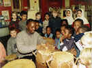 Luganda Sibandar demonstates Caribbean drums to pupils of Springfield School during the Afro-Caribbean Festival