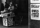 View: s27487 Newspaper seller, High Street
