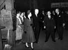 After watching the tapping of a furnace and talking to two workmen, Queen Elizabeth II accompanied by Mr. Herbert Renshaw and J.W. Foster at the English Steel Corporation, River Don Works, Brightside Lane during the royal visit   