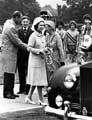 Queen Elizabeth II accompanied by HRH Duke of Edinburgh take leave of Lord Mayor, Councillor Mrs Winifred Mary Golding and Consort Mr. Arthur Golding, Hillsborough Park with some of the winning under 16 boys and girls relay teams in the background  