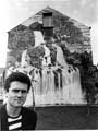 Tristram Carder, one of the artists, with a Waterfall Mural on the gable end of No. 48 Holland Road viewed from Alsine Road
