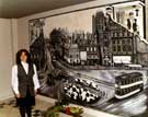 Angela Crenshaw with her Mural on the top floor of Orchard Square 