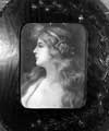 Portrait of a young lady in an oval carved wooden frame; an example of an early free gift by Hay and Son, wine merchants to regular customers
