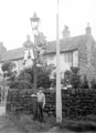 Village lads up the gas street lamp in front of Clubfold Cottages, Luke Lane, Wadsley