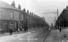 View: t00992 Nos. 164 - 162, grocers and off licence, 160, Post office, 158 etc., Petre Street from the junction with Lyons Street looking towards Petre Street Methodist Church in the background