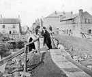 Sheffield Flood, damage at Owlerton Bridge over the River Loxley, Penistone Road. Eaton and Booth Ltd., tilters and forgers, Owlerton Bridge Steel Works, right. Bridge Inn, Bradfield Road, left