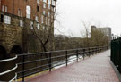 Completed section of the Five Weirs Walk footpath looking towards the Victoria Station Viaduct with the Royal Victoria Holiday Inn left looking towards the Hotel Bristol formerly Smithfield House in the background