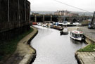 View of the moorings on South Yorkshire Navigation Canal from Cadman Street Bridge with Victoria Station Viaduct and Royal Victoria Holiday Inn in the background