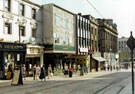 High Street showing the Supertram tracks; Turners, bakers (No.29); Today's Hair Salon;  Cavell's, cafe bar (No.31) and Valdis Shoes etc.