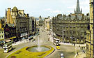 View: t03157 Elevated view of the Goodwin Fountain and Fargate showing shop including Nos. 68 Cantors Ltd, furnishers; 66, Dean and Dawson Ltd, travel agents; 62/64, Joan Barrie Ltd. (left), costumers and Yorkshire Bank Ltd (right)