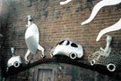 Car Mural Sculpture by Johnny White on the wall of Harratts Volvo Sheffield, Vulcan Foundry, Attercliffe Road