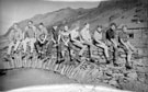 View: t03689 Stocksbridge Hill Rescue Team sitting on the bridge at Watendlath, Cumbria, c.1964/5