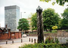 View: t03794 Pillars by Ross Gilbertson and Mandy Burton at the entrance to the Ponderosa, Crookes Valley Road/ Mushroom Lane with the Arts Tower and Weston Park in the background