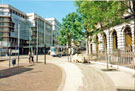 Supertram approaching Castle Square tram stop with Fighting Rams Sculpture by Jonathan Cox left and T. J. Hughes, department store during refurbishment right