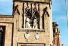 View: t04011 Carved detail, St. Maries, Roman Catholic Cathedral, representing the Annunciation above the door at the corner of Norfolk Row and Norfolk Street with Coats of Arms of Pope Leo XIII and Duke of Norfolk below