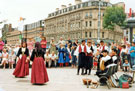 View: t04669 Cypriot Dance Team, Fargate during the World Student Games Cultural Festival with Pinstone Street in the background