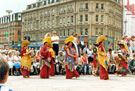 View: t04691 Tibetan Dance Team, Fargate with Pinstone Street in the background during the World Student Games Cultural Festival 