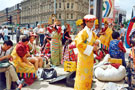 View: t04692 Tibetan Dance Team, Fargate with Pinstone Street in the background during the World Student Games Cultural Festival 