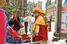 View: t04694 Tibetan Dance Team, Fargate with Pinstone Street in the background during the World Student Games Cultural Festival 