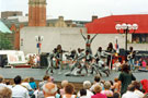 Mapapa Acrobats, Tudor Square during the World Student Games Cultural Festival with the Crucible Theatre in the background Mapapa Acrobats, Tudor Square during the World Student Games Cultural Festival with the Crucible Theatre in the background
