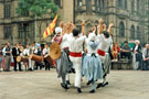 View: t04783 Lei Courcoussoun Dance Group from France performing in Fargate during the Cultural Festival with the Town Hall in the background