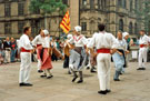 View: t04784 Lei Courcoussoun Dance Group from France performing in Fargate during the Cultural Festival with the Town Hall in the background