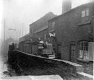 Slum housing and remains of buildings belonging to J. Chantrey's milk yard, (Mrs Emma Chantrey, shopkeeper, was situated at No. 58 Pond Hill), photographed from Pond Hill. Buildings stood opposite Sheaf Island Works with goit between